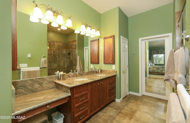 ensuite bathroom featuring connected bathroom, a shower stall, a sink, and double vanity