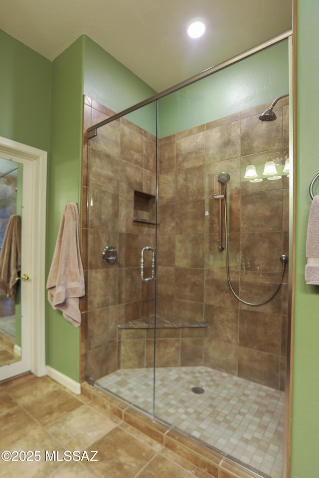 full bath featuring a stall shower and tile patterned flooring