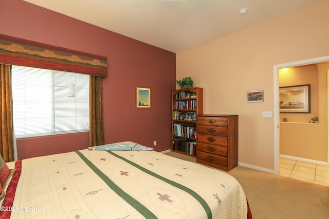 carpeted bedroom featuring tile patterned floors and baseboards