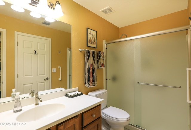 bathroom featuring a stall shower, visible vents, and toilet