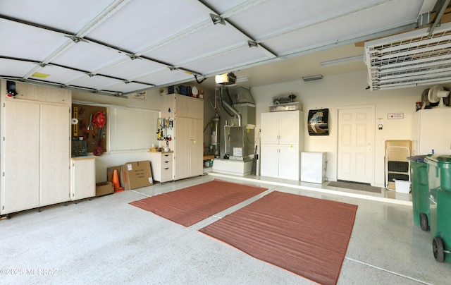 garage featuring heating unit and a garage door opener