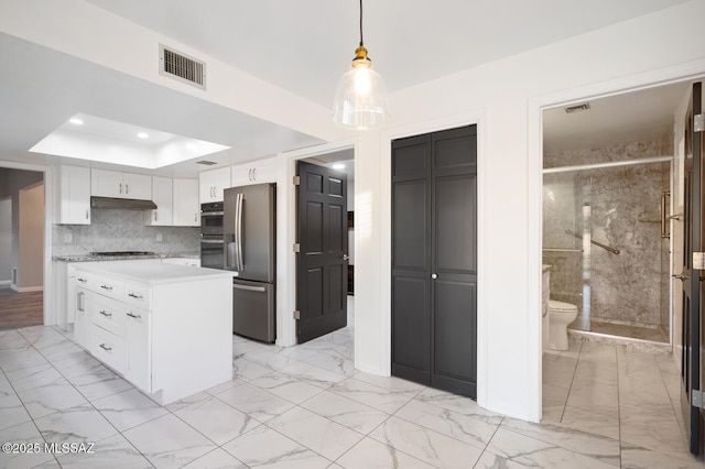 kitchen featuring marble finish floor, light countertops, visible vents, appliances with stainless steel finishes, and under cabinet range hood