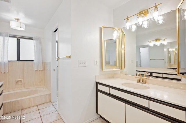 bathroom with a tub, vanity, baseboards, and tile patterned floors