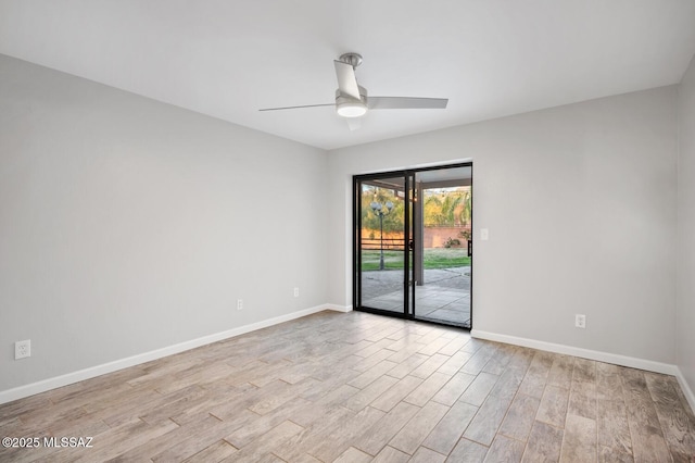 unfurnished room featuring light wood-style floors, baseboards, and a ceiling fan