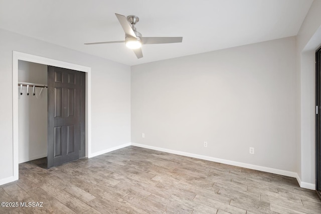 unfurnished bedroom with a ceiling fan, a closet, baseboards, and wood finished floors