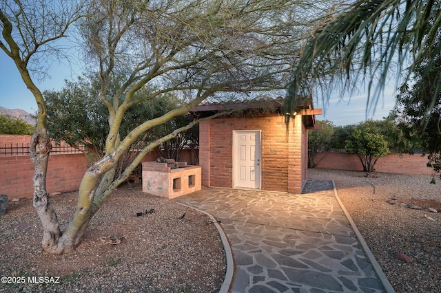 view of outbuilding with a fenced backyard and an outdoor structure