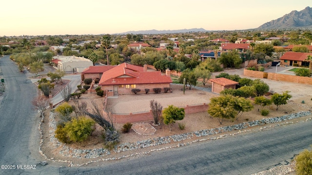 aerial view at dusk featuring a mountain view