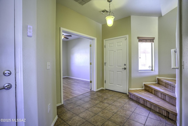 tiled foyer entrance with visible vents and baseboards