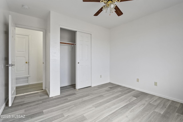 unfurnished bedroom featuring light wood finished floors, a closet, visible vents, ceiling fan, and baseboards