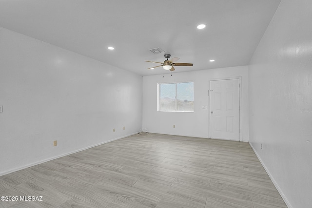 empty room featuring wood finish floors, recessed lighting, visible vents, a ceiling fan, and baseboards