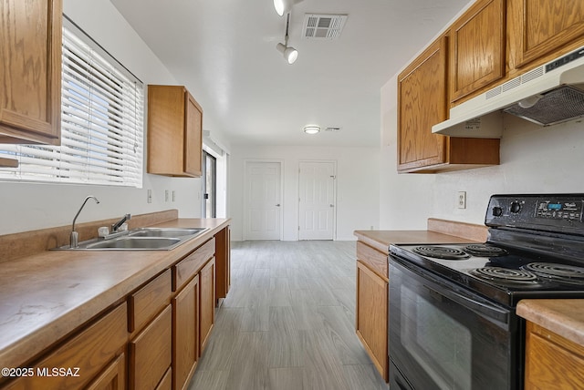 kitchen featuring brown cabinets, visible vents, black electric range oven, a sink, and under cabinet range hood