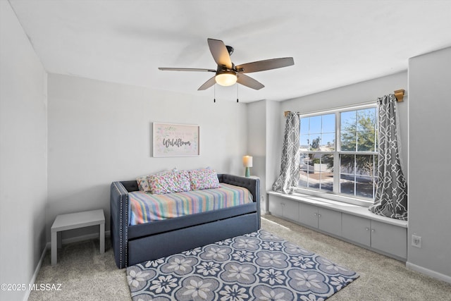 bedroom featuring light colored carpet, ceiling fan, and baseboards