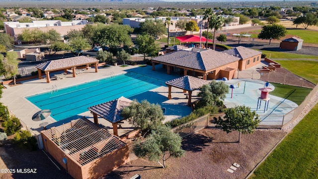 community pool with a residential view, a gazebo, and fence