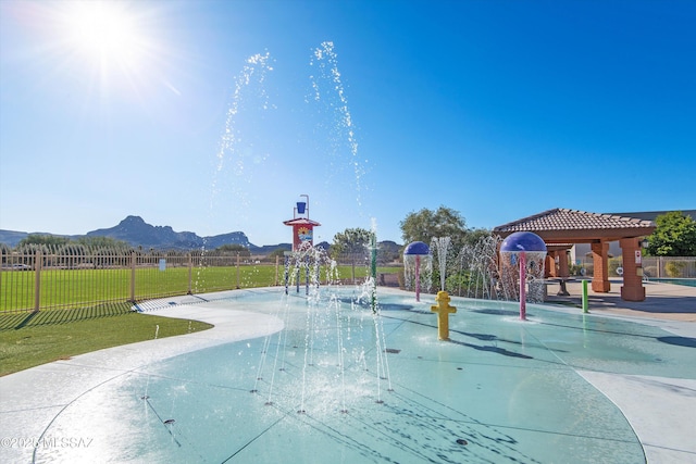 view of community featuring a mountain view and fence
