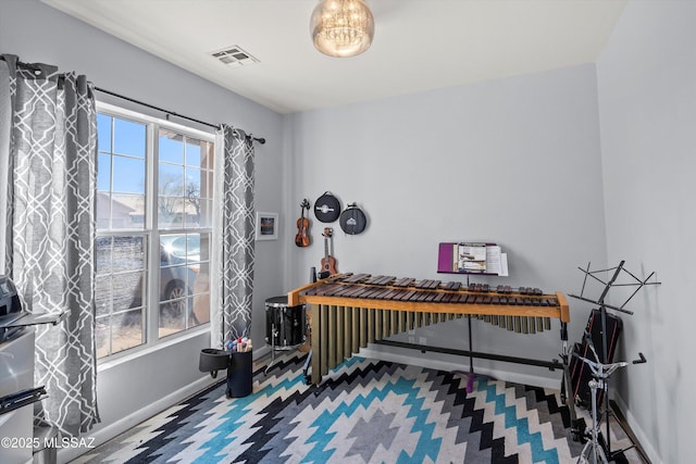 miscellaneous room featuring baseboards, visible vents, and carpet