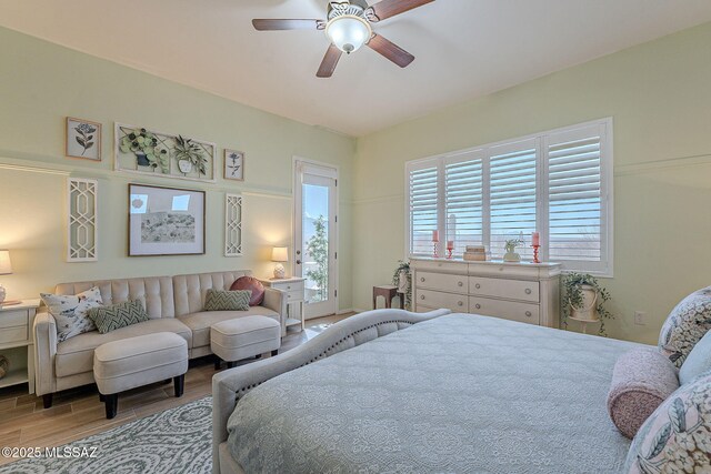 bedroom featuring access to exterior, ceiling fan, and wood finished floors