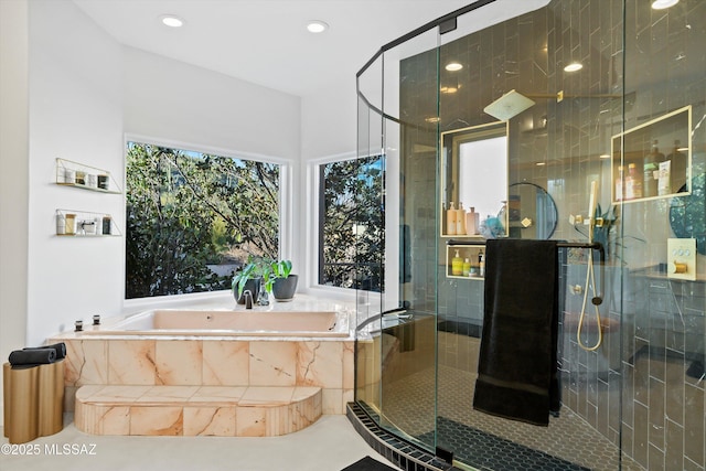 full bathroom with a stall shower, a garden tub, and recessed lighting