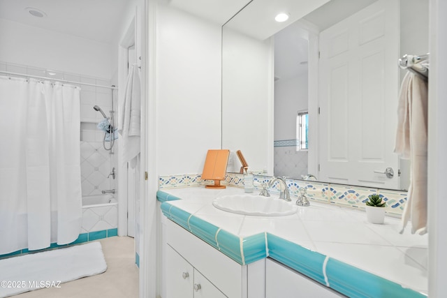 bathroom featuring shower / bathtub combination with curtain, backsplash, and vanity