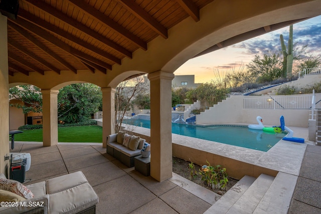 view of patio / terrace featuring fence, outdoor lounge area, and a fenced in pool