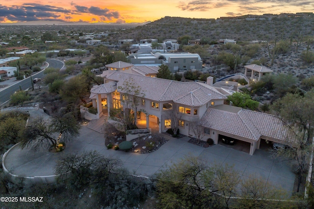 aerial view at dusk featuring a mountain view