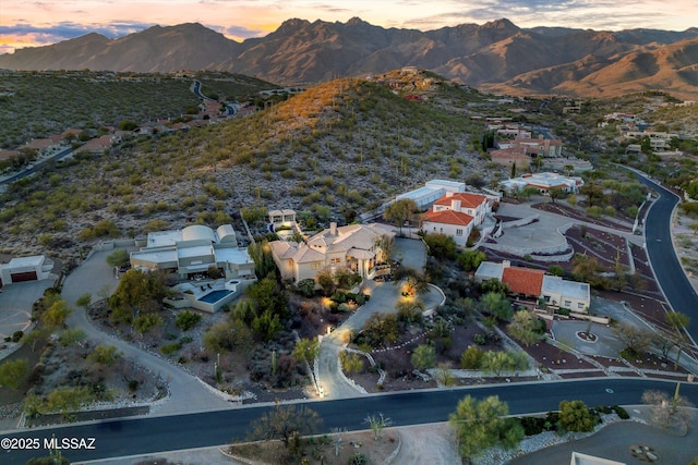 aerial view at dusk featuring a mountain view