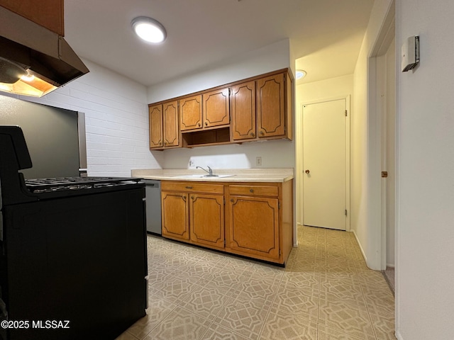 kitchen featuring brown cabinets, light countertops, a sink, black gas range oven, and under cabinet range hood
