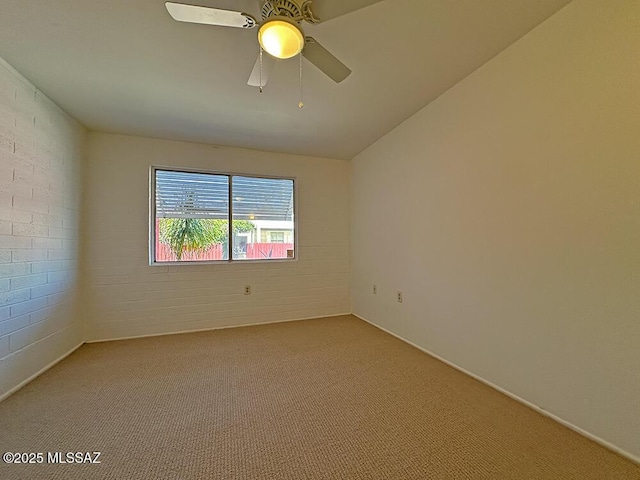 empty room featuring ceiling fan and light colored carpet