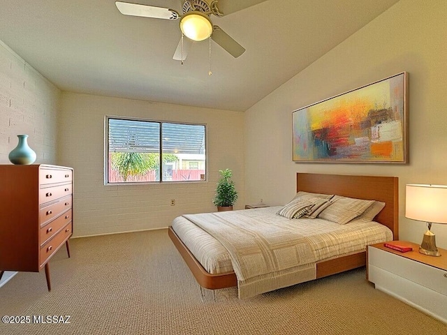 carpeted bedroom with a ceiling fan and vaulted ceiling