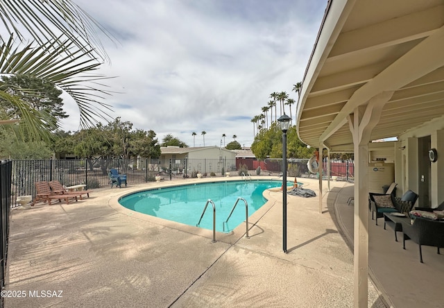 pool featuring a fenced backyard and a patio area