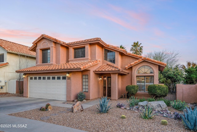 view of front facade with stucco siding, driveway, a tile roof, fence, and a garage