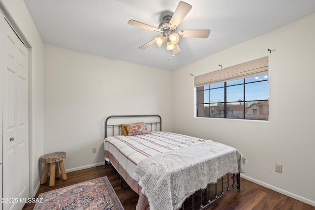 bedroom with a closet, baseboards, and wood finished floors