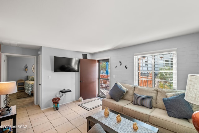 living room with light tile patterned floors and baseboards