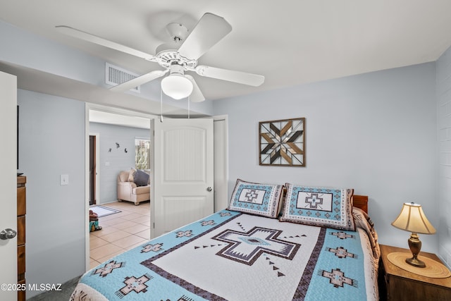 bedroom with tile patterned flooring, visible vents, and a ceiling fan