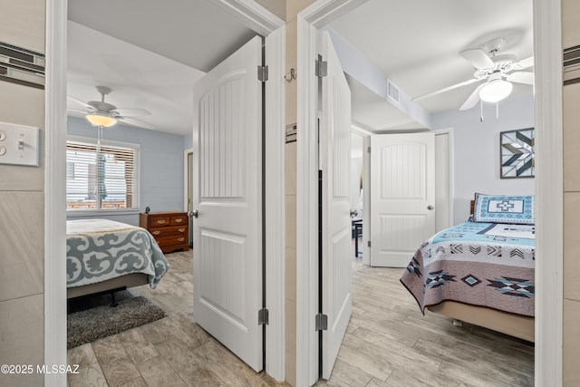 bedroom with visible vents, ceiling fan, and light wood-style flooring