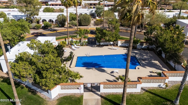 pool with a fenced front yard and a patio area