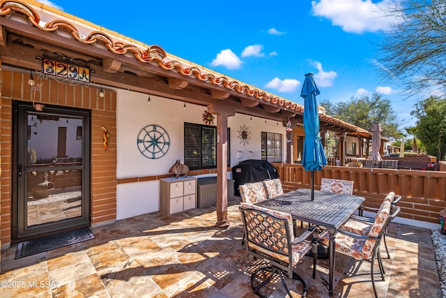 view of patio / terrace featuring grilling area and outdoor dining area