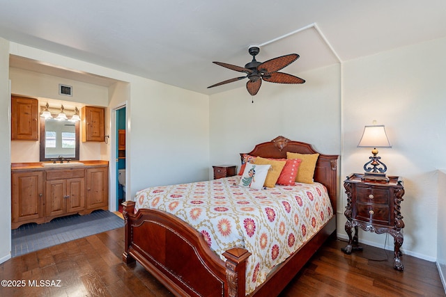 bedroom with a sink, visible vents, baseboards, and dark wood-type flooring