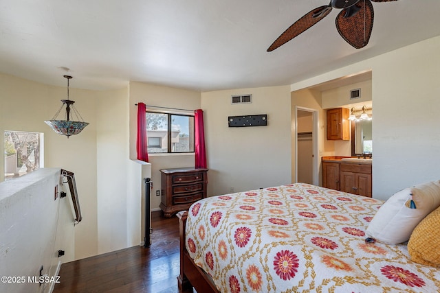 bedroom featuring visible vents, a sink, a ceiling fan, and dark wood-style flooring