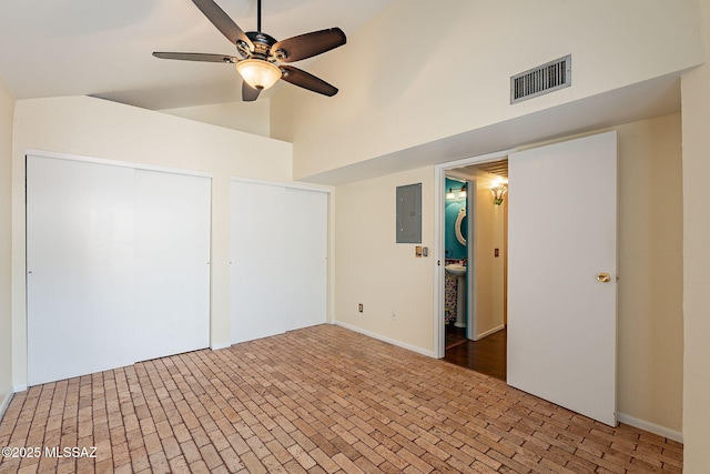 unfurnished bedroom featuring electric panel, visible vents, ceiling fan, and brick floor