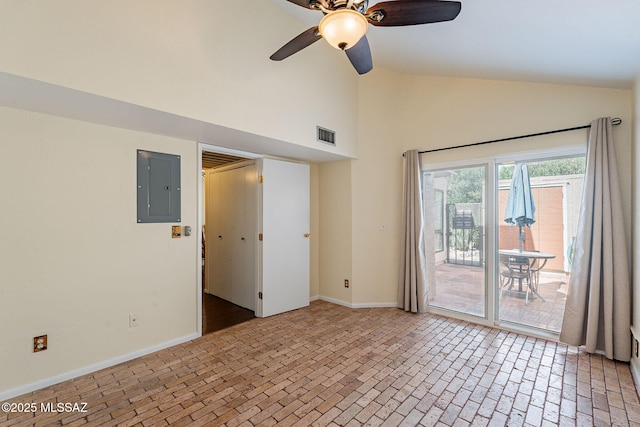 spare room with visible vents, baseboards, high vaulted ceiling, electric panel, and brick floor