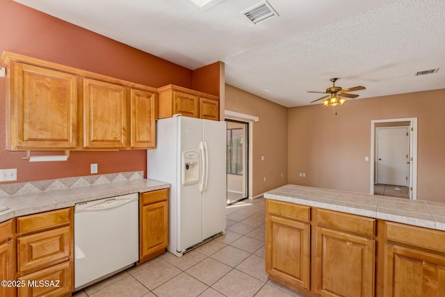 kitchen featuring white appliances, light tile patterned flooring, a ceiling fan, and visible vents