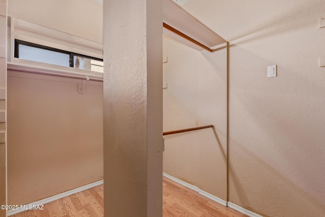 interior space with wood finished floors and baseboards