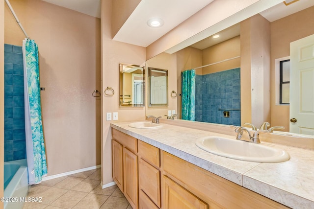 full bathroom with a sink, baseboards, shower / tub combo, and tile patterned floors