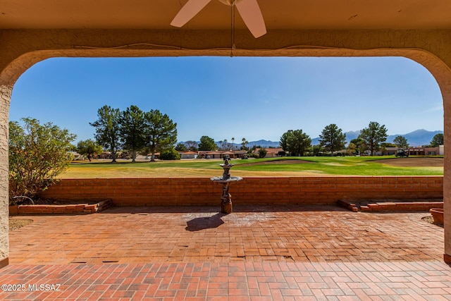 view of patio / terrace featuring a mountain view and a ceiling fan