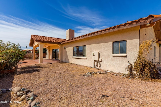 back of house featuring stucco siding, fence, and a patio area