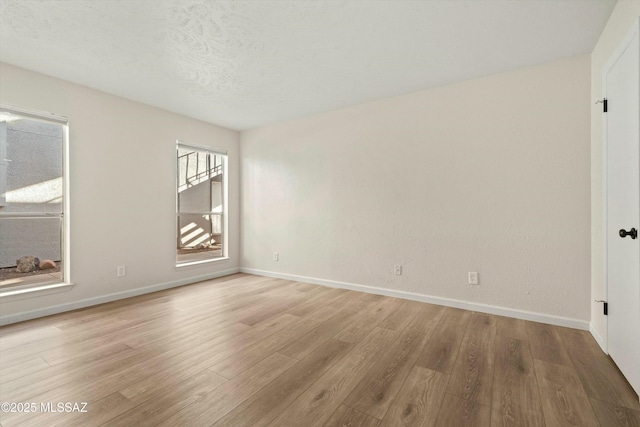 empty room featuring baseboards and wood finished floors