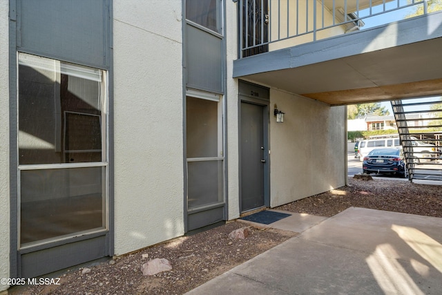 property entrance featuring a carport