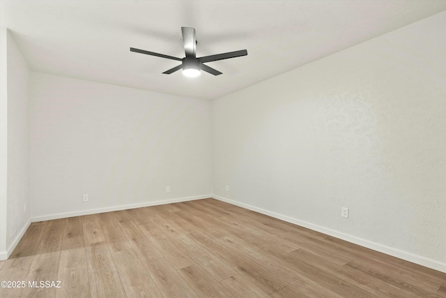 unfurnished room featuring a ceiling fan, light wood-type flooring, and baseboards