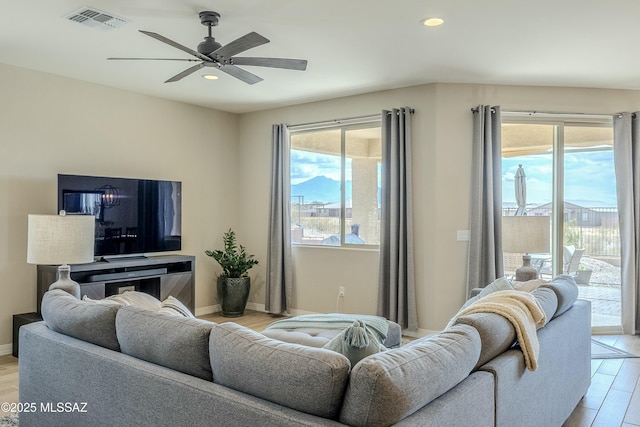 living area with visible vents, recessed lighting, light wood-type flooring, and a ceiling fan