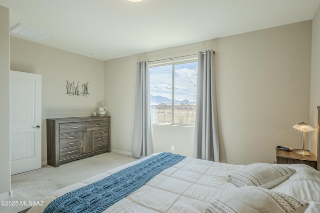 carpeted bedroom with baseboards and visible vents